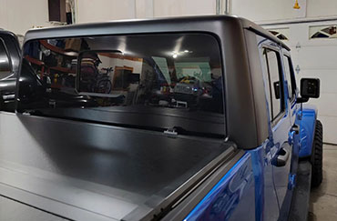 A closeup of a trucks tinted back windows