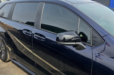 The side view of a dark blue car with tinted windows